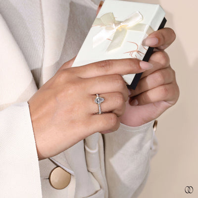 Pave engagement ring paired with pear cut diamond