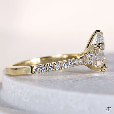Double claw prong ring securing pear cut diamond