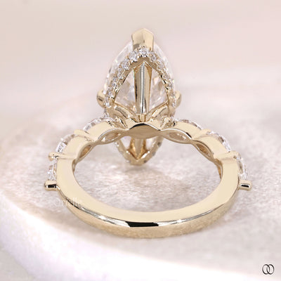 Marquise engagement diamond ring with claw prong and side diamonds