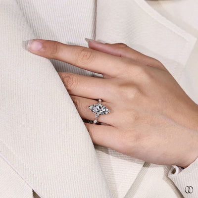 Unique setting marquise engagement ring with side diamonds in gold