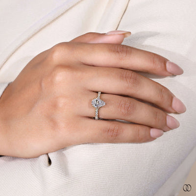 Hidden stone ring beneath pear cut diamond