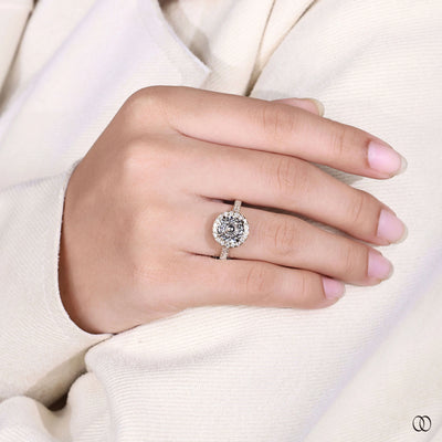Round diamond engagement ring with claw prong and pave diamonds