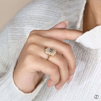 Yellow gold halo diamond engagement ring with emerald cut center