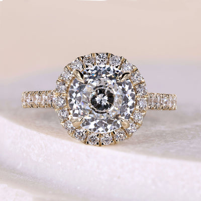 Round diamond solitaire engagement ring with claw prong yellow gold band