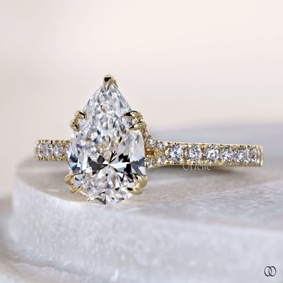 Unique pear cut diamond ring with pave engagement band