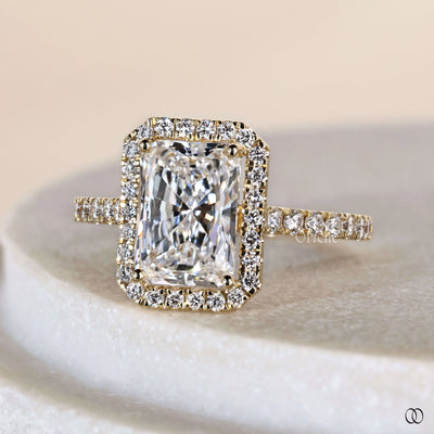 Unique engagement ring with radiant cut diamond and halo