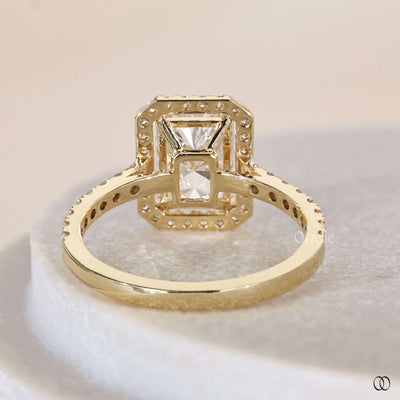 Radiant cut diamond ring framed by halo diamond ring