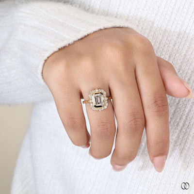 Bezel set engagement ring with emerald cut diamond and unique setting