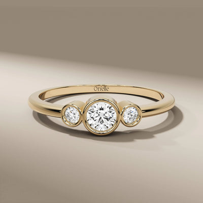 three stone wedding band in yellow gold with bezel setting