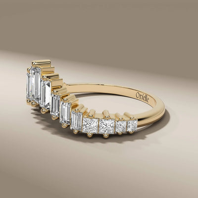 curved wedding band featuring baguette diamonds in prong setting
