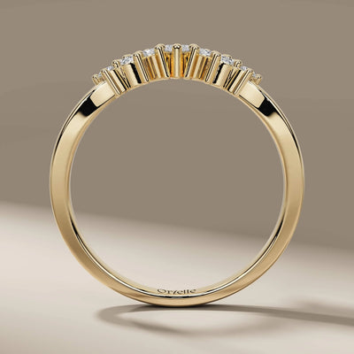 Designer curved wedding band with prong set marquise diamonds