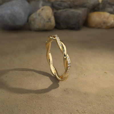 Yellow gold twisted band with round cut stones in prong setting
