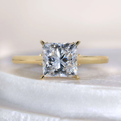 Princess cut diamond engagement ring in yellow gold
