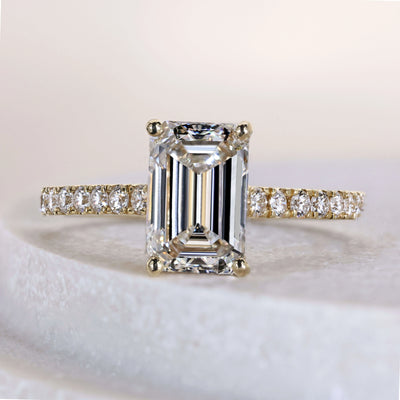 Emerald cut engagement ring in yellow gold setting
