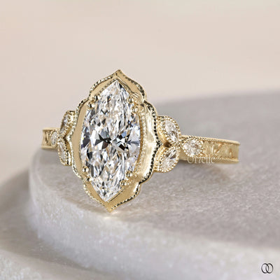 Marquise engagement ring with ornate frame halo design

