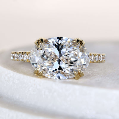 East west oval engagement ring in yellow gold setting
