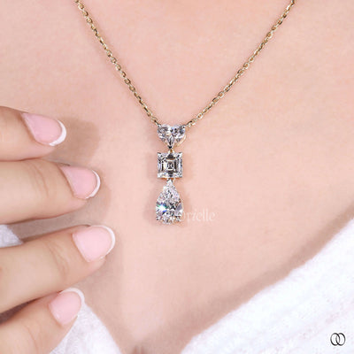 three diamond heart pendant in yellow gold setting
