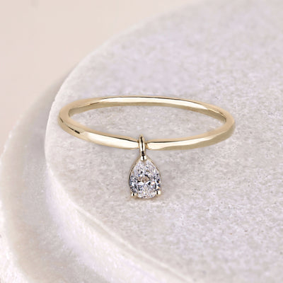 pear cut ring bezel set yellow gold solitaire ring
