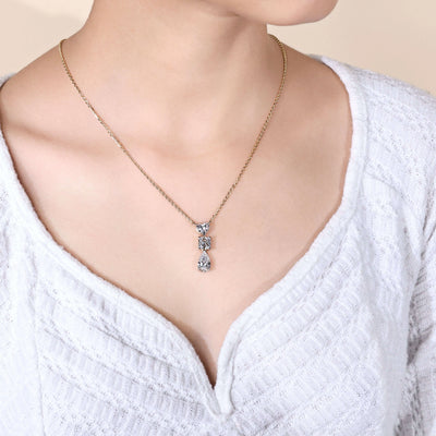 heart diamond pendant with princess and pear diamonds in gold
