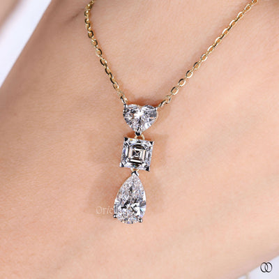 prong set heart diamond pendant with princess and pear cuts
