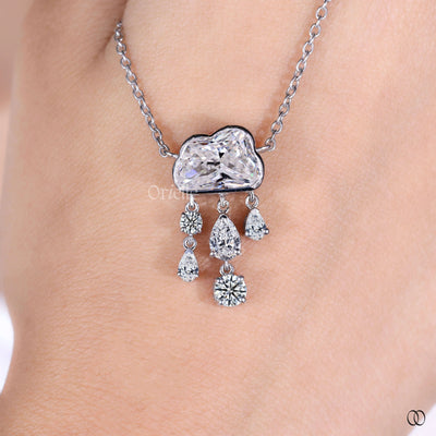 bezel set cloud diamond pendant with pear and round cuts

