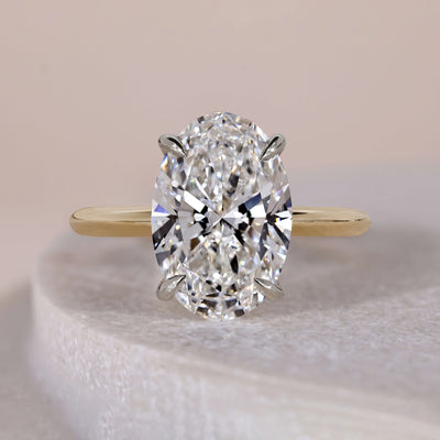 oval diamond engagement ring two tone design
