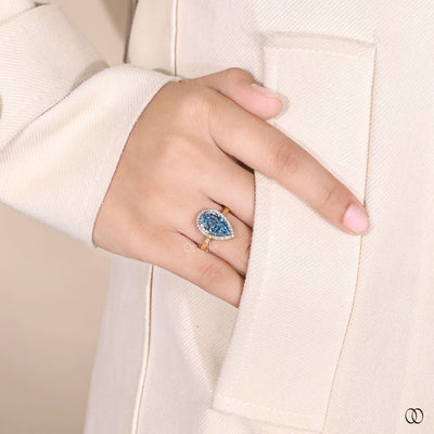 yellow gold ring vivid blue diamond halo
