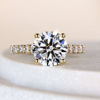 Round engagement ring in yellow gold cathedral setting
