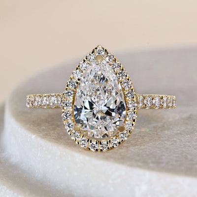 Pear engagement ring with pave engagement ring band
