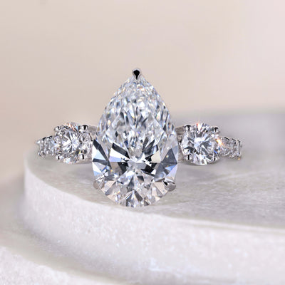 Pear cut diamond engagement ring with claw prongs and white gold band
