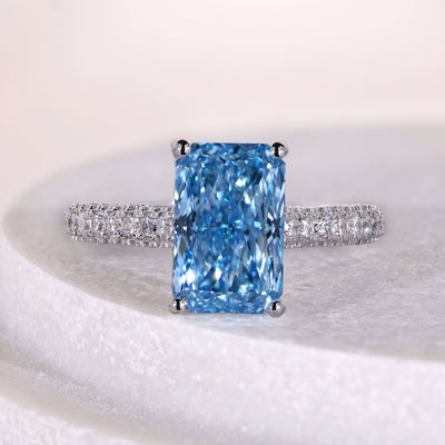 Radiant cut diamond engagement ring with hidden halo and pave band
