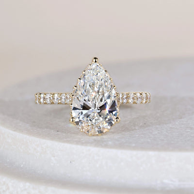 Pear engagement ring in yellow gold cathedral ring design

