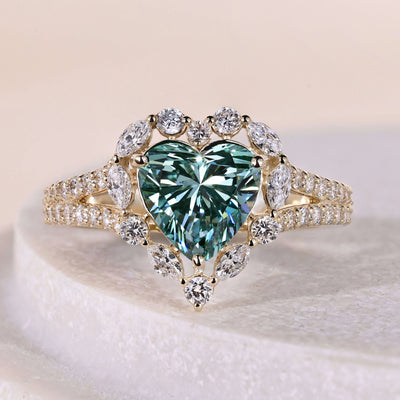 Heart shaped engagement ring with halo setting in yellow gold band
