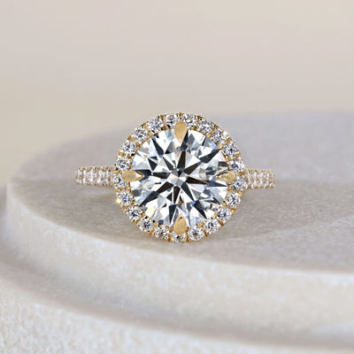 Round cut engagement ring in yellow gold cathedral setting
