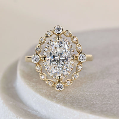 Oval engagement ring in yellow gold cathedral setting
