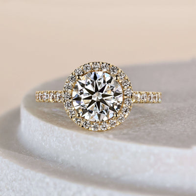 Round brilliant engagement ring in yellow gold cathedral setting
