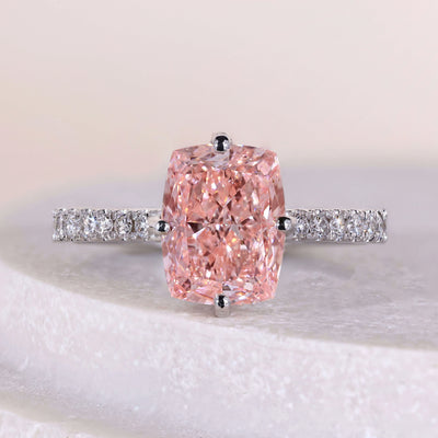 Elongated cushion cut diamond ring with hidden halo and pave band
