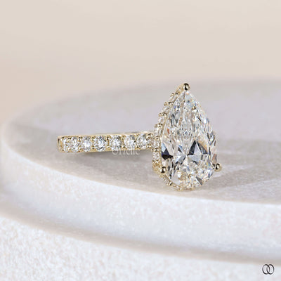 Unique engagement ring featuring pear diamond cathedral ring
