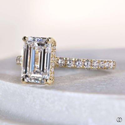 Unique emerald cut engagement ring with pave band
