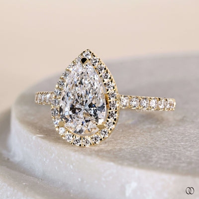 Unique engagement ring with pear center and halo diamond ring
