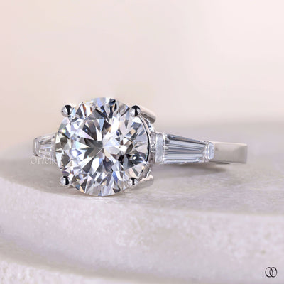 round cut diamond ring tapered baguette side stone ring
