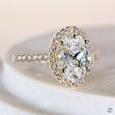 Unique engagement ring featuring oval diamond halo
