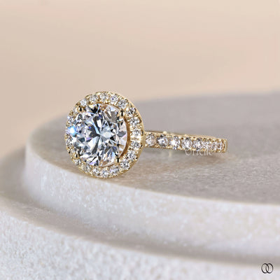 Unique engagement ring featuring round brilliant halo design

