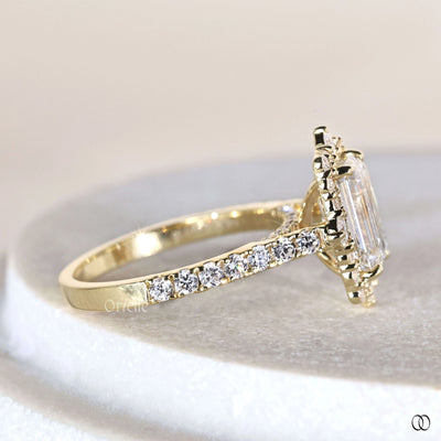 Luxury emerald cut engagement ring with round prong setting and halo diamonds
