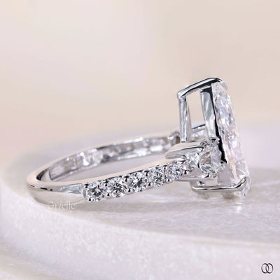 Pear cut diamond engagement ring with 3 stone diamond design
