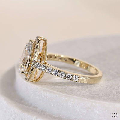 Yellow gold engagement ring with pear cut prong setting
