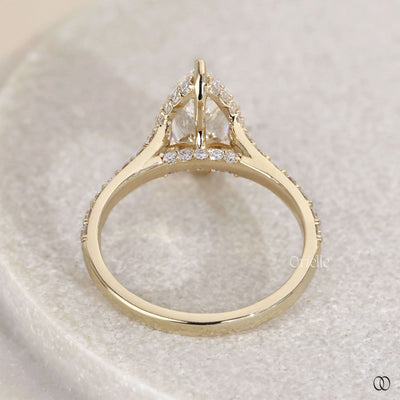 Pear engagement ring with hidden side stone detail
