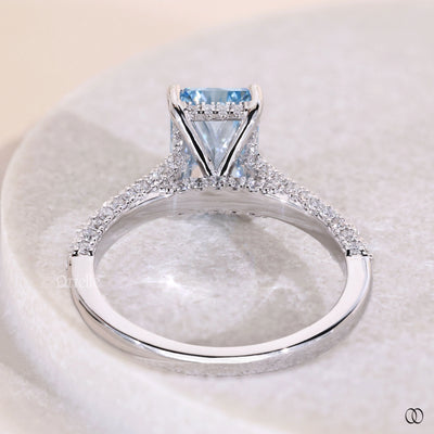 White gold radiant cut diamond ring with pave set engagement band
