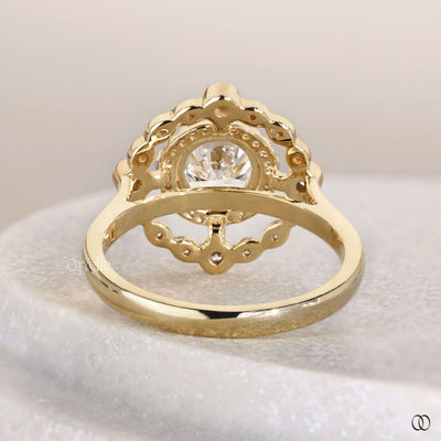 Round cut diamond ring framed by halo diamond ring
