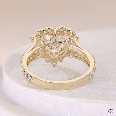 Yellow gold heart shaped diamond ring with cathedral engagement setting
